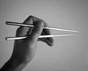 How do I hold chopsticks correctly?